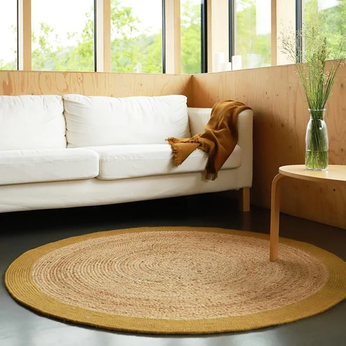 okrągły dywan YHUKI MANGO M z juty i wełny w kolorze naturalnym z pomarańczową obwódką mango, Ø140 cm, idealny do wnętrz boho i japandi