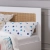 drewniane łóżko do pokoju dziecięcego w stylu boho i skandynawskim z rattanem
